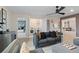 Relaxing living room includes stylish seating, ceiling fan, and view into adjacent rooms at 111 Felicity Pike, Locust Grove, GA 30248