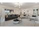 Open living space featuring modern decor, stylish furnishings, and a seamless transition to the kitchen at 111 Felicity Pike, Locust Grove, GA 30248
