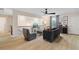 Bright living space with railing, modern lighting, comfortable seating, and wood-look flooring at 111 Felicity Pike, Locust Grove, GA 30248