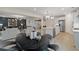 Open-concept living space with modern decor, flowing from the living room through the kitchen at 111 Felicity Pike, Locust Grove, GA 30248