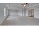 Large main bedroom featuring plush carpeting, tray ceiling, and ample natural light at 111 Felicity Pike, Locust Grove, GA 30248