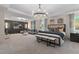 Spacious main bedroom boasts a lounge area, tray ceiling, a king bed, and a decorative accent wall at 111 Felicity Pike, Locust Grove, GA 30248
