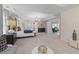 Bright, expansive main bedroom featuring a tray ceiling, lounge area, and ensuite bathroom access at 111 Felicity Pike, Locust Grove, GA 30248