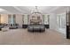 Expansive primary bedroom with sitting area, tray ceiling, and contemporary furnishings at 111 Felicity Pike, Locust Grove, GA 30248