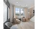 Cozy sitting area bathed in natural light, featuring comfortable chairs, a view, and easy access to the staircase at 111 Felicity Pike, Locust Grove, GA 30248