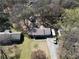 Aerial view of a home with a well-manicured lawn, trees, and a driveway with parking at 1312 Jordan Rd, Powder Springs, GA 30127