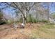 Large backyard with mature trees, seating, and fire pit at 1312 Jordan Rd, Powder Springs, GA 30127