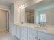 Bathroom featuring double sinks, modern vanity, and large mirror at 193 Haverling Pass, Hampton, GA 30228