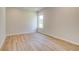 A well-lit room with hardwood flooring and a view from a large window at 193 Haverling Pass, Hampton, GA 30228