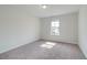 Bright bedroom with plush carpeting, a window offering natural light, and ample space for furnishings at 193 Haverling Pass, Hampton, GA 30228