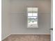 Spacious carpeted walk-in closet featuring metal racks and a bright window overlooking the home's exterior at 193 Haverling Pass, Hampton, GA 30228