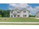 Beautiful two-story white brick home with a manicured lawn and a welcoming blue front door at 193 Haverling Pass, Hampton, GA 30228