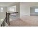 Carpeted upstairs hallway with decorative railing and transom window above the front door, creating an open feel at 193 Haverling Pass, Hampton, GA 30228