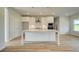 Modern kitchen featuring a large center island, stainless steel appliances, and stylish pendant lighting at 193 Haverling Pass, Hampton, GA 30228