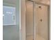 Close-up of modern glass shower with white tile and modern fixtures at 193 Haverling Pass, Hampton, GA 30228