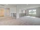 Upstairs carpeted living room featuring an open layout, transom window, and decorative railing by the stairs at 193 Haverling Pass, Hampton, GA 30228