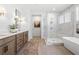 Bathroom featuring a modern shower, soaking tub, and double vanity with great lighting at 5120 Token Chase, Cumming, GA 30040