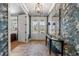 Elegant foyer with wallpaper, wood floors, and stylish lighting fixtures at 5120 Token Chase, Cumming, GA 30040