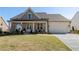 Charming single-Gathering home with a covered front porch and a well-manicured lawn at 5120 Token Chase, Cumming, GA 30040