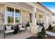 Inviting covered porch with chairs, creating a cozy outdoor living space at 5120 Token Chase, Cumming, GA 30040