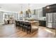 Open-concept kitchen with large island, stainless steel appliances, and adjacent dining area at 5120 Token Chase, Cumming, GA 30040