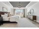 A large, bright main bedroom with decorative ceiling, large windows, and stylish furniture at 5120 Token Chase, Cumming, GA 30040