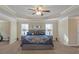 Large primary bedroom boasting tray ceilings, soft carpet, offering a luxurious retreat at 205 Bergen Dr, Fayetteville, GA 30215