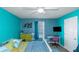 Bright bedroom featuring turquoise walls, a ceiling fan, and a dedicated desk area for work or study at 205 Bergen Dr, Fayetteville, GA 30215