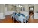 Formal dining room with hardwood floors, wainscoting, chandelier, and seating for six guests at 205 Bergen Dr, Fayetteville, GA 30215