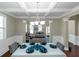 Bright dining room featuring coffered ceilings, modern chandelier, and seating for six at 205 Bergen Dr, Fayetteville, GA 30215