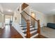 Elegant foyer features a wood staircase, hardwood floors, and wainscoting at 205 Bergen Dr, Fayetteville, GA 30215