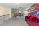 Hallway at the top of the steps features neutral carpet and a red couch on the right at 205 Bergen Dr, Fayetteville, GA 30215