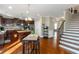 Spacious kitchen flowing into the staircase, with stainless appliances and eat-in island at 205 Bergen Dr, Fayetteville, GA 30215