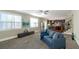 Open concept living room with bright windows, carpet, and an open entry into the kitchen at 205 Bergen Dr, Fayetteville, GA 30215