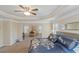 Spacious main bedroom features a tray ceiling, ceiling fan, sitting area and decorative bedding at 205 Bergen Dr, Fayetteville, GA 30215