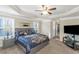 The main bedroom features a ceiling fan, neutral paint and carpet with a television at 205 Bergen Dr, Fayetteville, GA 30215