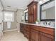 Bathroom featuring dual sinks, granite counters, dark wood cabinets, and tile flooring at 2733 Eagle Ridge Rd, Marietta, GA 30062