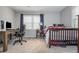 Bright bedroom featuring a bed, desk, and large window that brings in plenty of natural light at 2733 Eagle Ridge Rd, Marietta, GA 30062