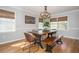 Elegant dining room featuring a modern chandelier, a wooden table with bench, and natural light at 2733 Eagle Ridge Rd, Marietta, GA 30062