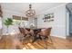 Stylish dining room featuring a modern chandelier, a wooden table with seating, and natural light at 2733 Eagle Ridge Rd, Marietta, GA 30062