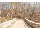 Stone bridge over pond surrounded by trees with couple walking at 2733 Eagle Ridge Rd, Marietta, GA 30062