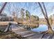 Stone bridge crosses a serene community pond with a fountain and trees reflecting in the water at 2733 Eagle Ridge Rd, Marietta, GA 30062