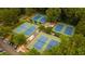 Aerial view of multiple outdoor tennis courts surrounded by trees at 2733 Eagle Ridge Rd, Marietta, GA 30062