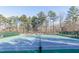 View of community tennis courts surrounded by mature trees and landscaping at 2733 Eagle Ridge Rd, Marietta, GA 30062