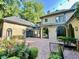 Picturesque backyard with a brick patio, lush greenery, and string lights, perfect for outdoor gatherings at 973 Peachtree Battle Ave, Atlanta, GA 30327