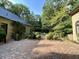 Charming backyard with brick patio, manicured bushes, and fountain for enjoying the natural landscape at 973 Peachtree Battle Ave, Atlanta, GA 30327