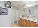 Bright bathroom featuring a double sink vanity, framed art, and a bathtub with shower at 3641 Devenwood Way, Buford, GA 30519