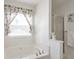 Luxurious garden tub next to separate shower, with window view at 3641 Devenwood Way, Buford, GA 30519