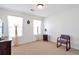 Bright, neutral bedroom with ample natural light from two windows and carpet flooring at 3641 Devenwood Way, Buford, GA 30519