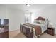Comfortable bedroom with a wooden bed frame, carpeted floors, and neutral paint at 3641 Devenwood Way, Buford, GA 30519